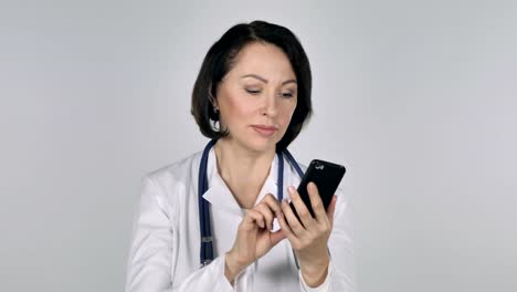 Lady-Doctor-Browsing-Smartphone,-White-Background