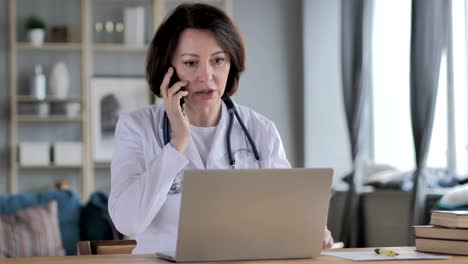 Old-Lady-Doctor-Discussing-with-Patient-During-Phone-Talk