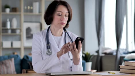 Old-Lady-Doctor-Using-Phone-for-Internet