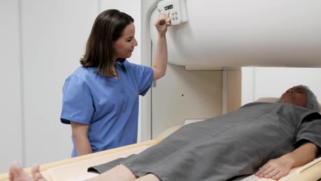 Portrait-Of-Friendly-Successful-Doctor-Smiling-At-Camera-During-MRI