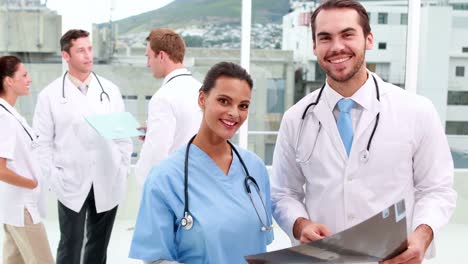 Medical-team-smiling-at-camera-together