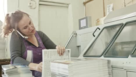 Polygraph-printing-process---a-woman-speak-telephone-and-make-manual-labor