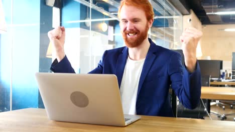 Man-Celebrating-Success,-Working-on-Laptop