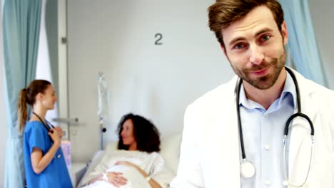 Portrait-of-smiling-male-doctor-holding-clipboard