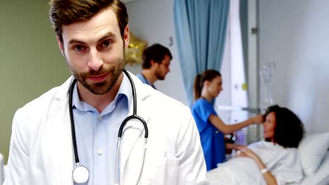 Portrait-of-smiling-male-doctor-using-digital-tablet