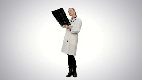 Female-doctor-looking-at-xray-of-human-brain-on-white-background