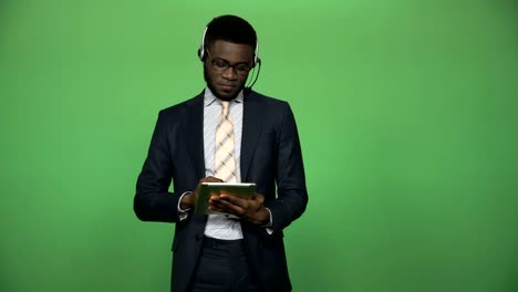 African-male-support-call-center-with-tablet-and-headset