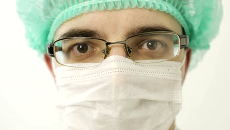 Close-up-of-a-male-doctor-in-a-mask-looking-at-the-camera.