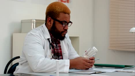 African-american-male-medical-worker-prescribing-pills