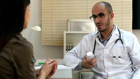 Male-medical-worker-describing-and-giving-pills-to-worried-woman-patient