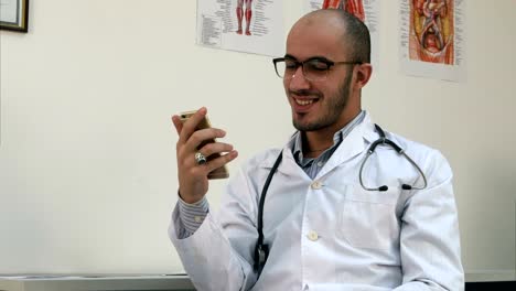 Medical-worker-checking-his-phone-and-laughing-at-something