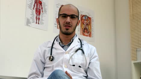 Positive-male-arabian-doctor-with-stethoscope-talking-to-the-camera