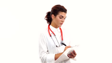 Friendly-young-female-doctor-reviews-and-writes-notes-on-a-clipboard.-Portrait-of-young-medical-professional-with-stethoscope-and-lab-coat-isolated-on-white-background