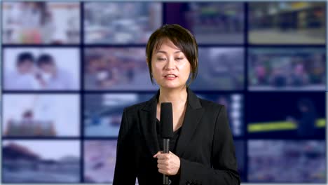 News-anchorwoman-in-studio-with-banks-of-screens-in-background