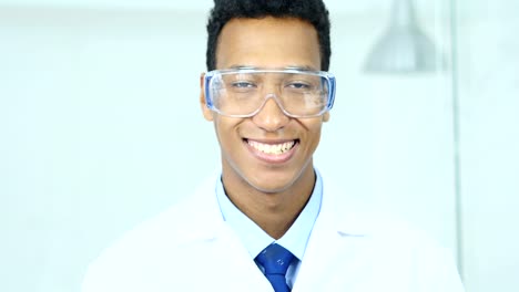 Close-Up-of-Smiling-Scientist,-Doctor-in-Protective-Glasses