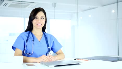 Smiling-Positive-Doctor-in-Clinic-Looking-at-Camera