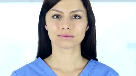 Close-Up-of-Doctor-Looking-At-Camera-in-Clinic