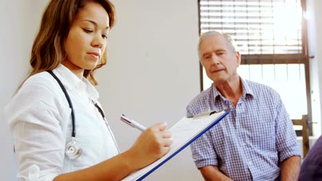 Portrait-of-physiotherapist-writing-on-clipboard-4k