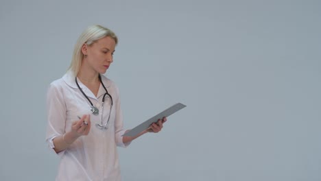 serious-Young-female-doctor-in-white-room-writing