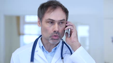 Doctor-Talking-on-Phone,-Attending-Phone-Call