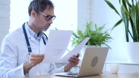 Doctor-Writing-Medical-Report-of-patient-in-Clinic