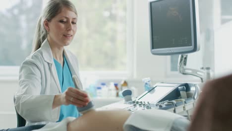 In-the-Hospital,-Obstetrician-Uses-Transducer-for-Ultrasound/-Sonogram-Screening-/-Scanning-Belly-of-the-Pregnant-Woman.-Computer-Screen-Shows-3D-Image-of-the-Healthy-Forming-Baby.