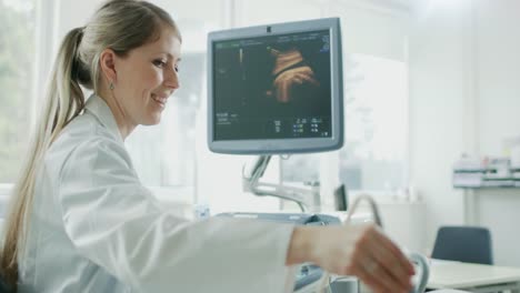 In-the-Hospital,-Obstetrician-Uses-Transducer-for-Ultrasound/-Sonogram-Screening-/-Scanning-Belly-of-the-Pregnant-Woman.-Computer-Screen-Shows-3D-Image-of-the-Healthy-Forming-Baby.