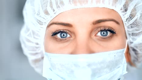 Medical-nurse-or-scientist-in-surgical-mask-on-blurred-background-in-a-hospital-or-laboratory