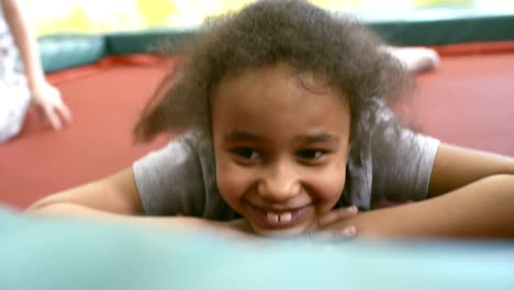 Black-Girl-Lying-on-Trampoline-and-Smiling