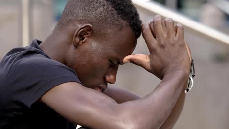 Sad-black-african-migrant-alone-praying-in-the-street