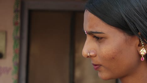 Beautiful-Indian-newly-married-young-woman-in-traditional-costumes-in-domestic-setting-clothes-looks-worried-thinks-deep-looks-around-walk-in-out-frame-focus-shift-lock-down-static-suspicious-curious