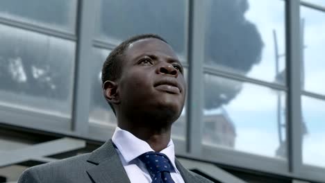 Thoughtful-young-black-american-business-man-in-the-street