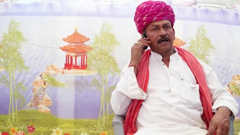 MS-of-Indian-man-seated-and-talking-on-the-phone-with-traditional-clothes