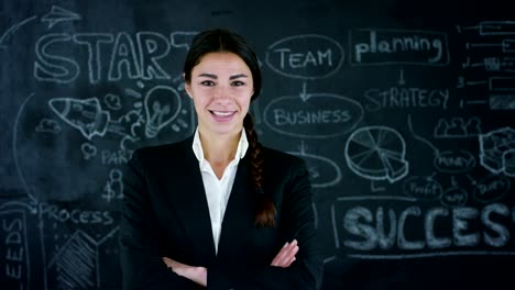 Beautiful-business-girl,-marketing-teacher,-draws-a-graph-of-success-on-a-black-board,-on-a-black-background.