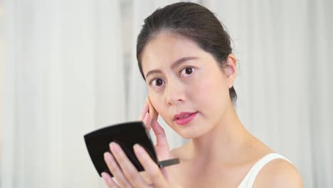 woman-using-sponge-apply-makeup