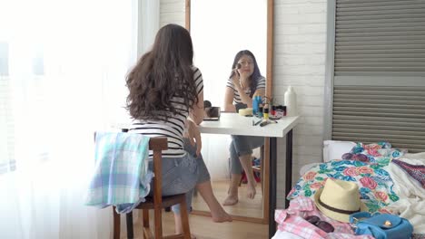 girl-using-her-cell-phone-and-makeup