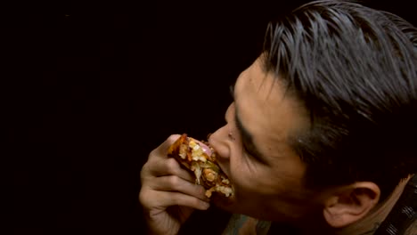 slow-motion-asian-tattooed-man-voraciously-eats-a-slice-of-pizza