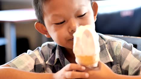 Cute-asian-boy-are-happy-eating-ice-cream-in-restaurant.-Video-4k-Slow-motion