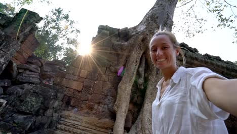 Travel-female-taking-selfie-portrait-at-ancient-temple