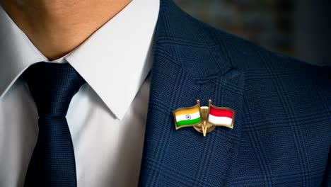 Businessman-Walking-Towards-Camera-With-Friend-Country-Flags-Pin-India---Indonesia