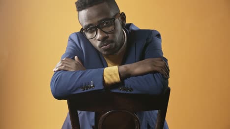 Confident-Black-Man-Sitting-on-Chair