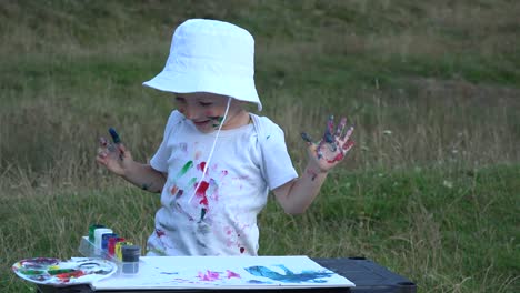 Happy-child-painting,-smiling-clapping-hands,-dirty-face,-hands,-clothes