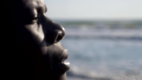 migration,-africa,-sea.-Profile-of-black-man-near-the-ocean--change-of-focus