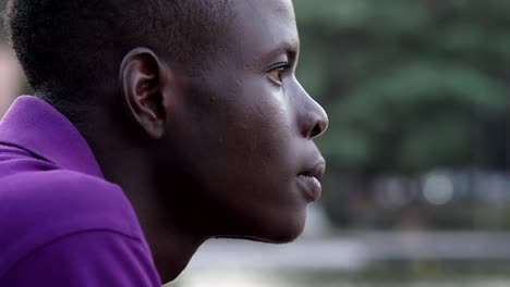 Pensive-attractive-american-african-young-man-at-the-park--profile