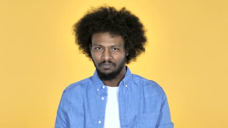 Afro-American-Man-Shaking-Head-to-Reject-on-Yellow-Background