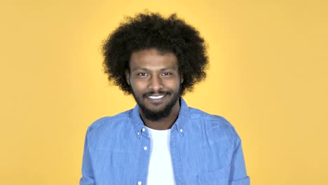 Flying-Kiss-by-Afro-American-Man-on-Yellow-Background