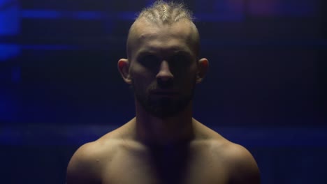 portrait-of-serious-professional-sportsman-is-set-for-final-fighting-in-twilight