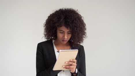 African-american-businesswoman-writing-on-notepad