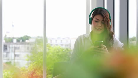 Asian-woman-listening-music-from-her-Smartphone.