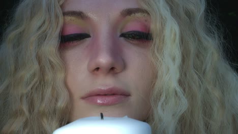 4k-Fantasy-Shot-of-a-Fairy-Blowing-up-a-Candle,-close-up